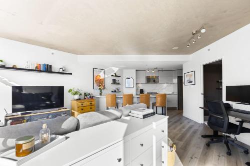 an open living room with a couch and a table at Luxury Central Apartment with City Views in Vancouver