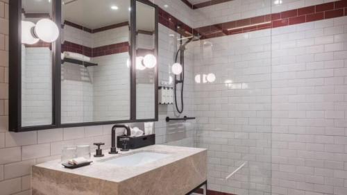 a bathroom with a sink and a mirror at Kimpton Margot Sydney by IHG in Sydney