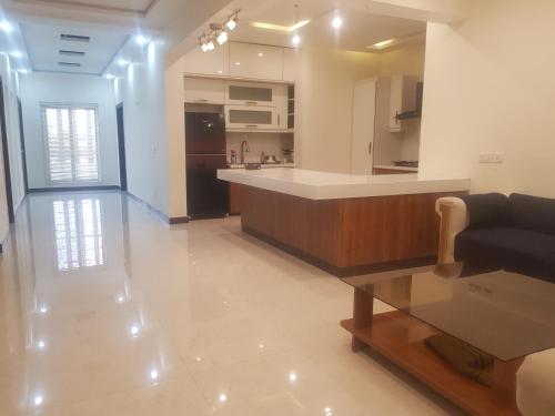 a kitchen and living room with a couch and a table at Haven Lodge - 7BR Luxury Vacation Home with Mountain View in Islamabad