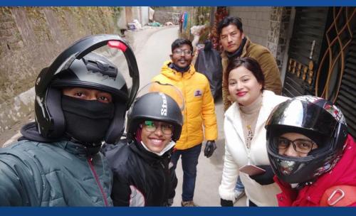 a group of people are wearing helmets on a motorcycle at shalom inn home stay in Darjeeling