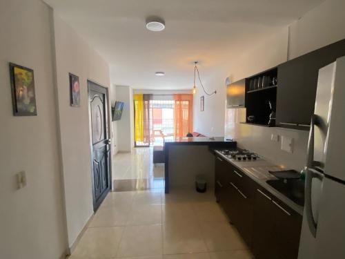 a kitchen with a refrigerator and a counter top at Apartamento En Villa del Prado in Cali