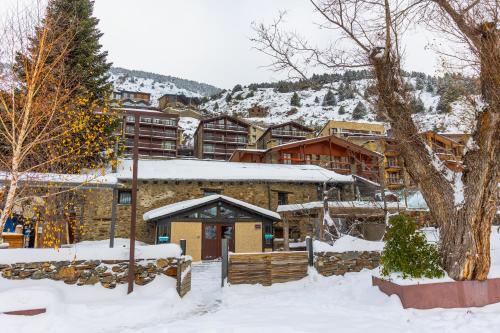 a resort in the snow with a building at Mountain Hostel Tarter in El Tarter