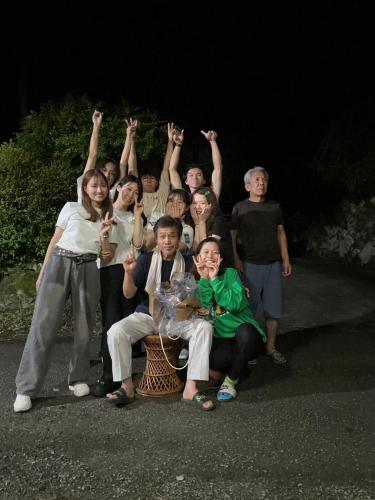 a group of people are posing for a picture at Ryuo Field in Kikuchi