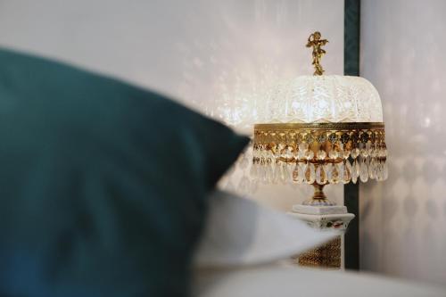 a lamp sitting on a bed next to a pillow at Boutique Hotel View in Amsterdam