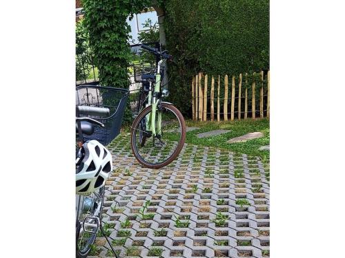 a bike parked in a yard next to a fence at Blum - vom Ende Comfortable holiday residence in Altmünster