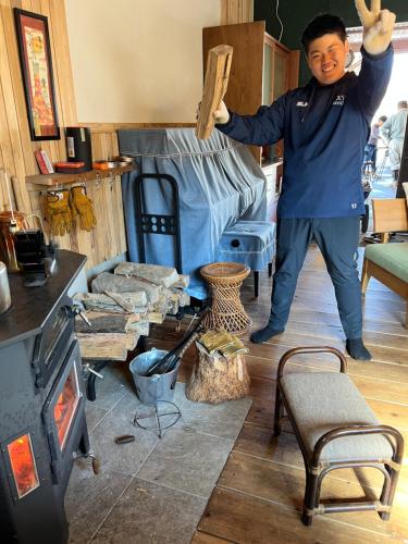 a man standing in a room holding a stick at Ryuo Field in Kikuchi