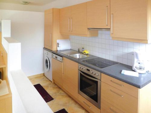 a kitchen with a sink and a stove top oven at Farmhouse on Mieminger Plateau with Mountain Views in Mieming