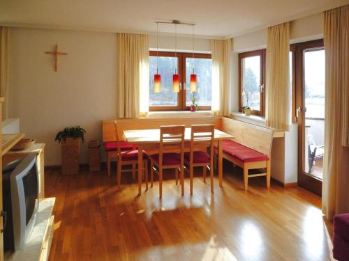 a dining room with a table and chairs and a cross at Farmhouse on Mieminger Plateau with Mountain Views in Mieming