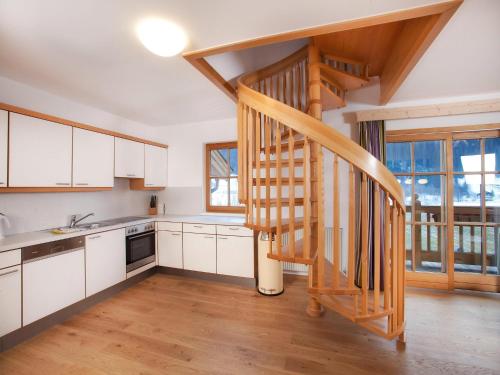 a kitchen with a spiral staircase in a house at Apartment in Wald im Pinzgau near Ski Lift in Wald im Pinzgau