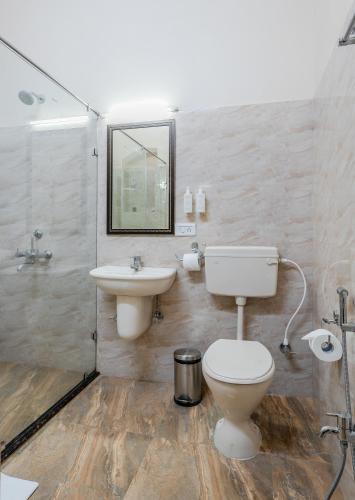 a bathroom with a toilet and a sink at IL Palazzo Heritage Resort in Panchgani