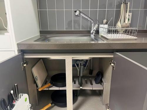 a kitchen with a sink and a counter top at Yeonsan The Stay in Busan