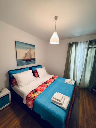 a bedroom with a bed with two towels on it at Adriatic Escape Apartments in Mokošica