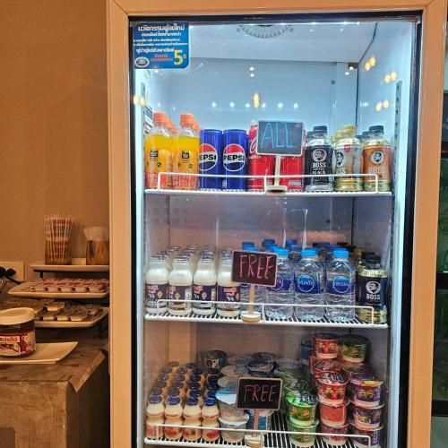 a refrigerator filled with lots of drinks at Sawasdee​ Buriram​ Resort in Buriram