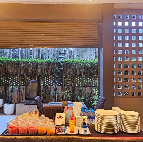a table with plates of food on top of it at Sawasdee​ Buriram​ Resort in Buriram