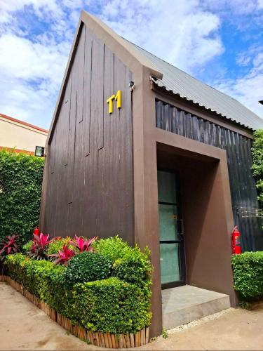 a building with the m on the side of it at Sawasdee​ Buriram​ Resort in Buriram