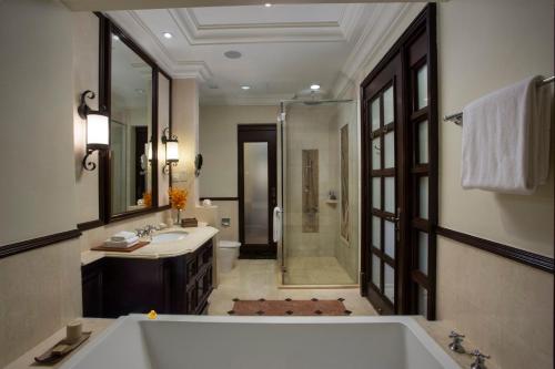 a bathroom with a tub and a sink and a shower at Casa del Rio Melaka in Melaka