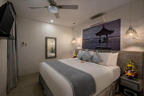 a bedroom with a large bed and a tv at Ozamiz Villa Seminyak by Bali Villas R Us in Seminyak