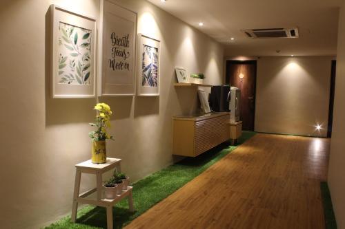 a room with a hallway with a tv on a dresser at Sojourn Spa Hotel in Kuala Lumpur