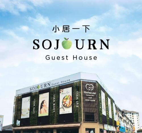 a sign for a guest house in front of a building at Sojourn Spa Hotel in Kuala Lumpur