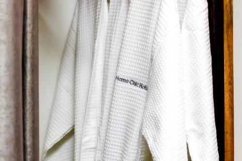 a white curtain with a sticker on it at Home Chic Hotel in Phnom Penh