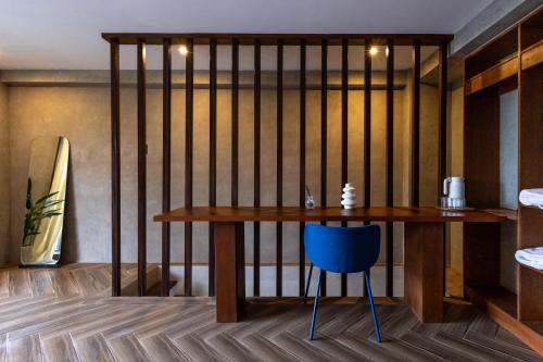 a room with a wooden table and a blue chair at Asgard Resort & MMA Gym in General Luna