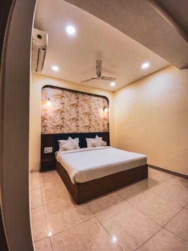 a bedroom with a large bed in a room at The Blue Vista in Greater Noida