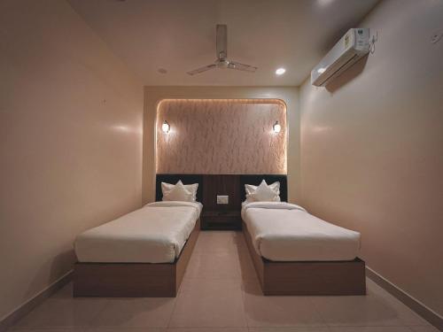 a room with two beds in a room at The Blue Vista in Greater Noida
