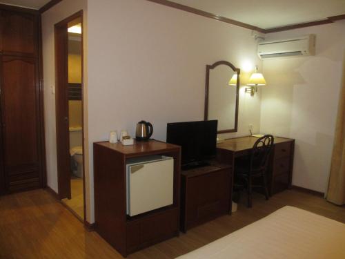 Postel nebo postele na pokoji v ubytování Sanbay Hotel