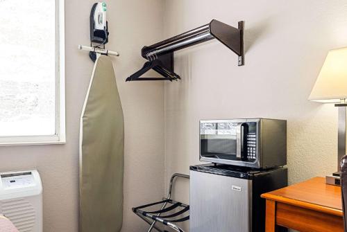a room with a microwave and a refrigerator at Super 8 by Wyndham Pittsburgh/Monroeville in Monroeville