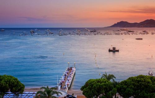 a group of boats on a dock in the water at Hôtel Martinez, in The Unbound Collection by Hyatt in Cannes