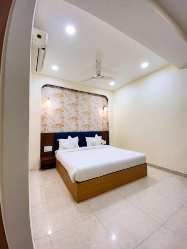 a bedroom with a large bed in a room at The Blue Vista in Greater Noida