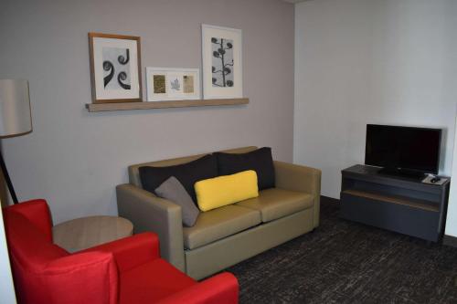 a living room with a couch and a chair and a television at Country Inn & Suites by Radisson, Hagerstown, MD in Hagerstown