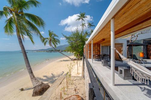 a house on the beach with a view of the ocean at Pao Jin Poon Villa in Lamai