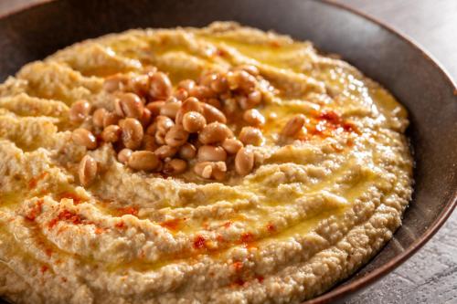 a bowl of hummus with beans on top of it at KAMENOI HOTEL Tazawako in Senboku