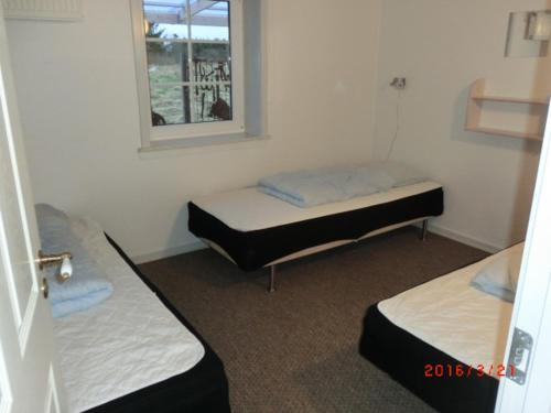 Un pat sau paturi într-o cameră la Langelund Apartments