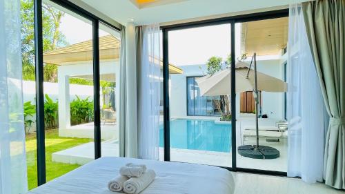 Ένα ή περισσότερα κρεβάτια σε δωμάτιο στο Mouana Residence Song Khun Chalong