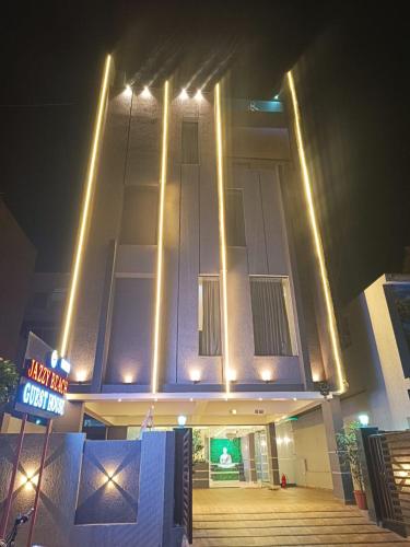 a building with lights on top of it at night at Jazzy Beach Guest Rooms in Visakhapatnam