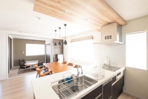 a kitchen with a sink and a dining room at Tokuno Zoo Street in Asahikawa