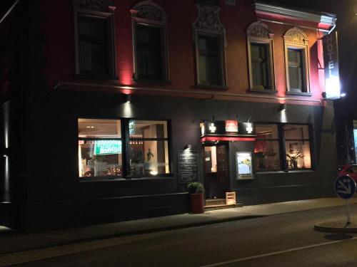 a restaurant on a city street at night at Hotel Hoppe in Witten