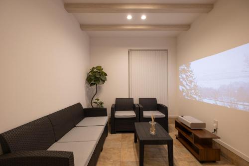 a living room with a couch and a table at Tokuno Zoo Street in Asahikawa