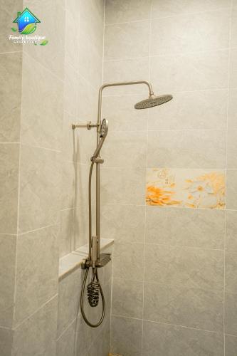 a shower with a shower head in a bathroom at Family Boutique in Kampot