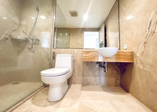 a bathroom with a toilet and a sink at Lavish The Peak 2BR Apartment in Tunjungan Plaza 5 Surabaya City Centre by Le Ciel Hospitality in Surabaya