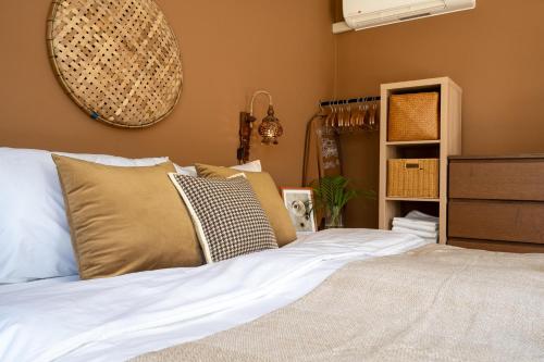 a bedroom with a bed with pillows on it at Manao Seaview Pool Villa38A - 5Mins Walk To Beach in Ko Lanta