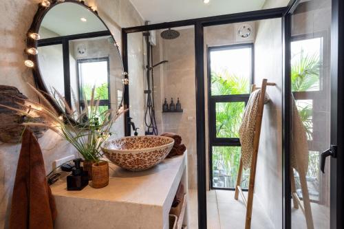 a bathroom with a large mirror and a sink at Manao Seaview Pool Villa38A - 5Mins Walk To Beach in Ko Lanta