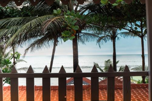 a view of the beach from a fence at Nasya Beachside Cottages in Benaulim