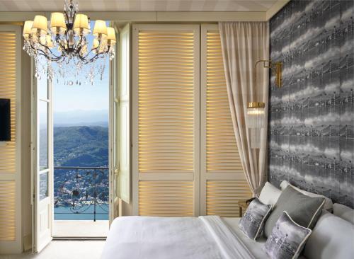 a bedroom with a bed and a large window at Nuvole Garden Hotel in Brunate