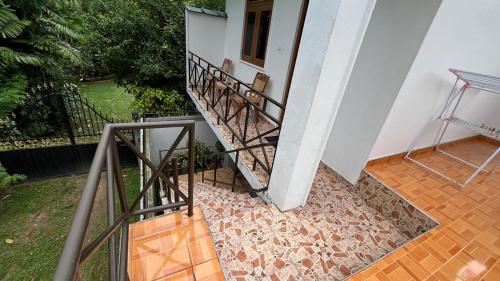 a stairway leading up to a building with a balcony at Ravi Guset Habaraduwa in Habaraduwa