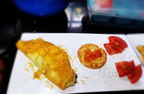 a white plate with a piece of food and a pastry at A Cherry Lane Self Catering and B&B in Bloemfontein