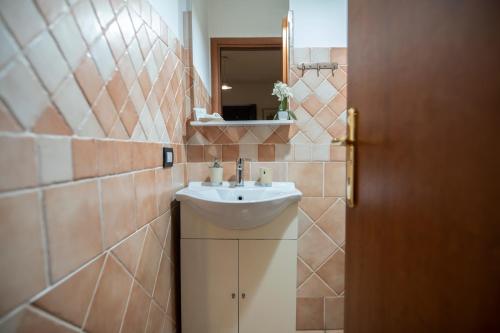 a bathroom with a sink and a mirror at Domoruja B&B in Sassari