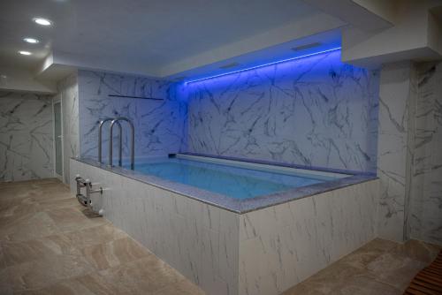 a bathroom with a tub with a blue lighting at Lime house in Kyustendil